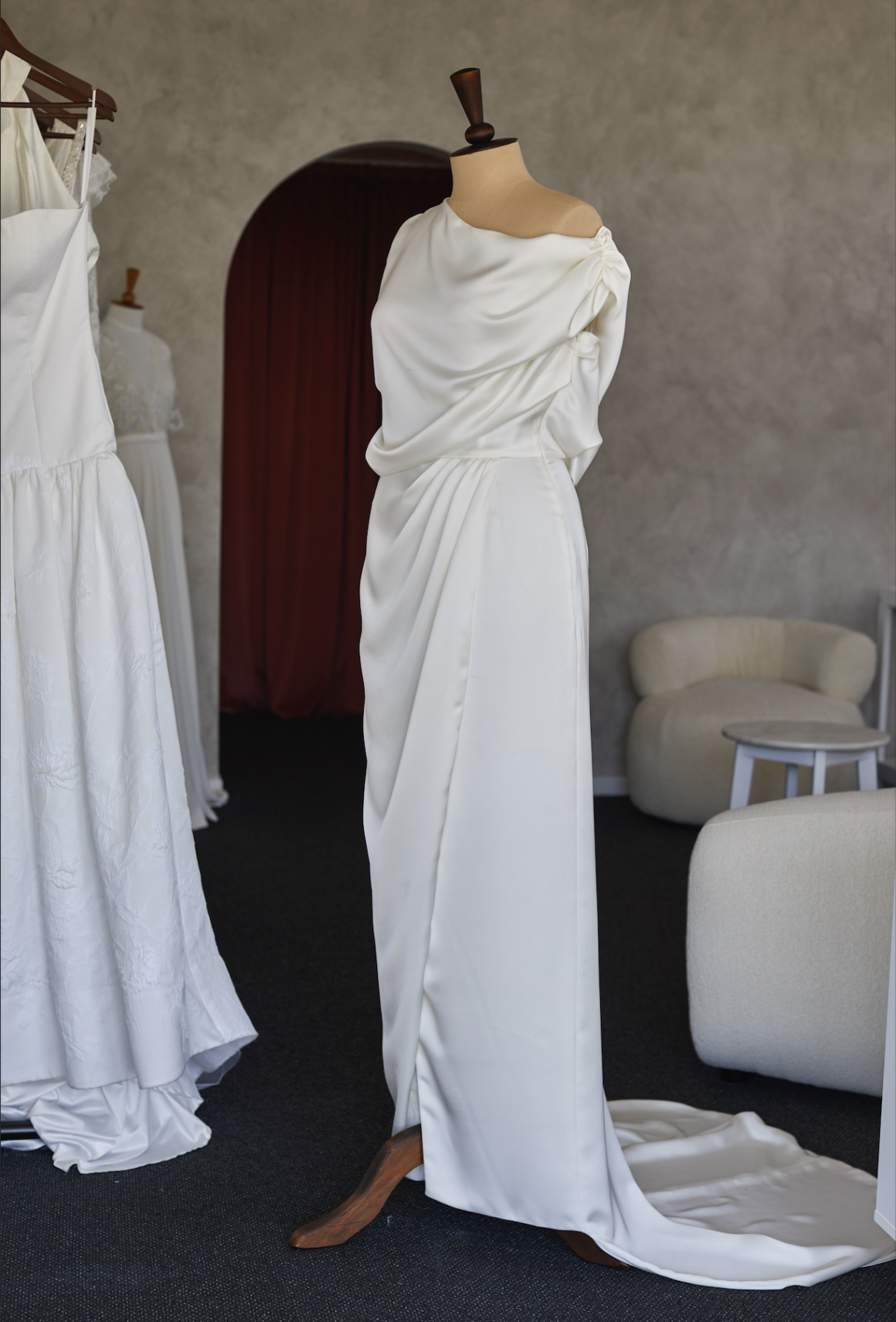 Preparing a wedding dress for a fitting appointment in her boutique